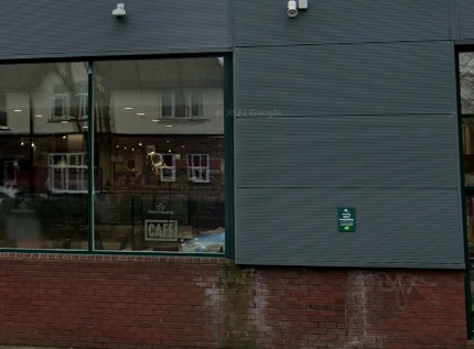 A google street view picture of the side of Morries, showing one of the windows to the cafe